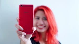 Red haired girl using red OPPO F3
