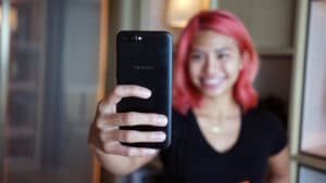 Pink haired girl holding OPPO R11